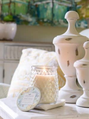 Bella Freesia Signature Candle on side table